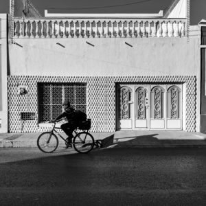 Man on a bicycle Walking in Merida MX by Birgit Pauli-Haack